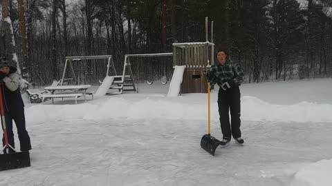 Clearing the ice rink after snowfall