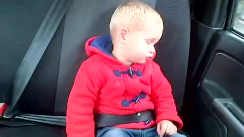 baby struggles to stay awake on a drive