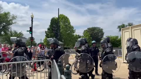 Police in riot gear making their way to the U.S. Supreme Court.