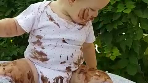 Dessert-loving baby completely covers herself in chocolate