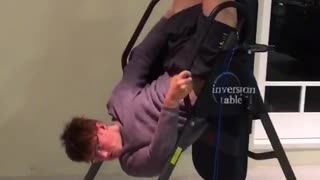 Guy slips off of vertical ab workout machine