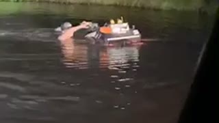 Guy Pushes Four-Wheeler Through the Pond