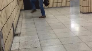 Old guy in suit kicks leg up at wall