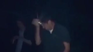 Guy in dark shirt cracks beer on head it sprays everywhere