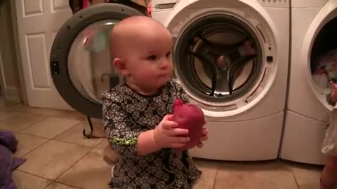 Babies lovingly help mom with clothes