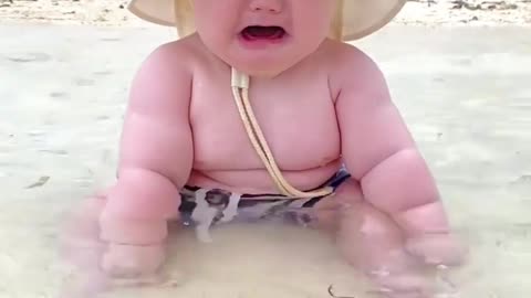 Cute baby scared water