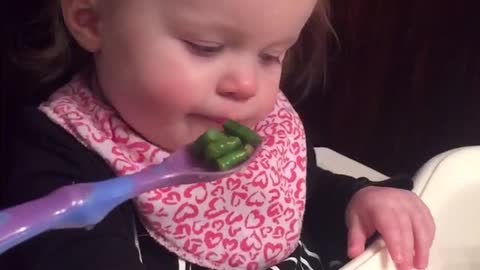 Baby gets extremely emotional over green beans