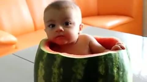 Baby sitting inside a Watermellon
