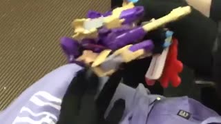 Person playing with purple lego toy on train