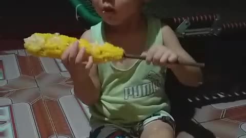 the son eats corn for the first time