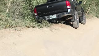 Car Hangs Precariously off Mountain Trail