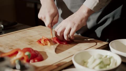 Cheif Slicing a Red Chilli with a Knife