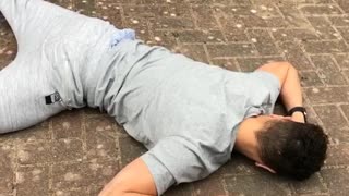 Grey sweatpants on skateboard falls down on sidewalk