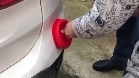 Using boiling water and a plunger to remove car dents
