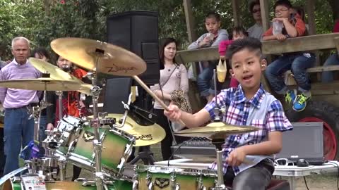 Young boy play drum extremely well.