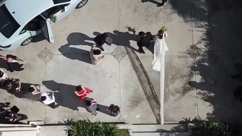 Newlyweds entering their wedding car