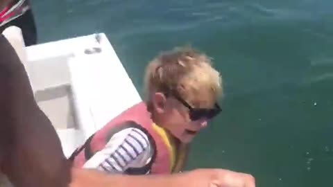 Little boy helps dad catch a lot of fishStarting early. 6-year-old Jack helps his dad,
