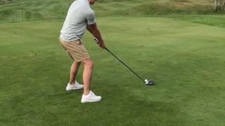 Guy grey shirt playing golf knocks out chunk of grass