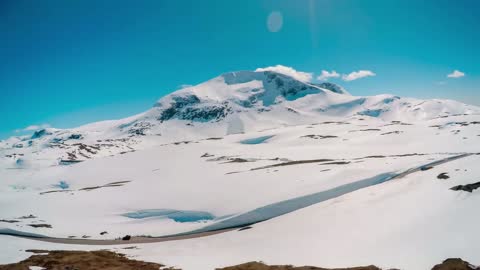 mountain road in norway with high snow wall