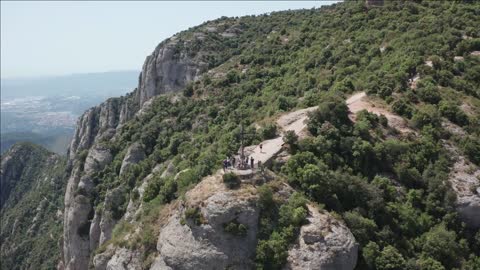 aerial view of rocky range of montserrat with cross of saint michael on background