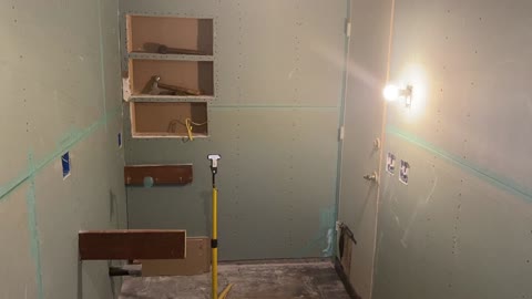 Getting shower curb coated with thin-set and floating out shower walls.