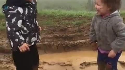 Happy Kids Playing in the Mud