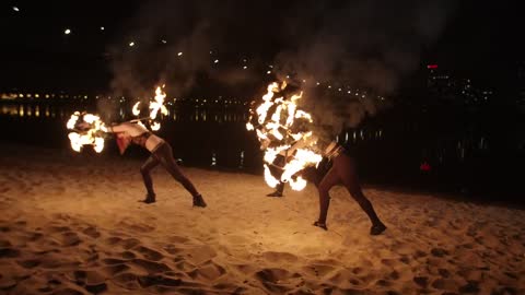 Fire jugglers on a beach