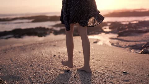 A woman walking on a seashore FHD