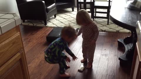 Twin Toddlers Fighting over Paintbrush