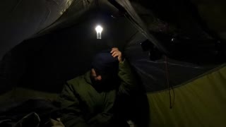 Getting ready for bed inside a tent while wildcamping in a woodland