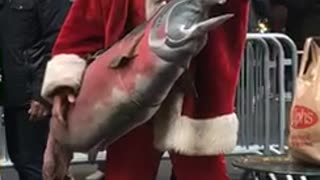 Giant tuna old man santa costume on street