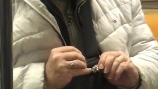 Man in white jacket lipping hand nails