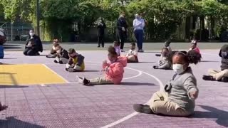 Children turn into conductors during outdoor symphony at school