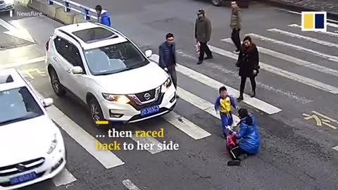 The boy kicks the man's car that hit his mother