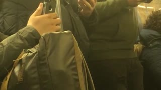 Man chews on and eats his earphone standing on subway