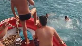 Guy slips on red boat falls into water