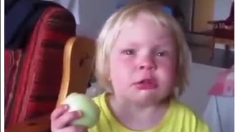 Child eating an onion thinking it's an aaple