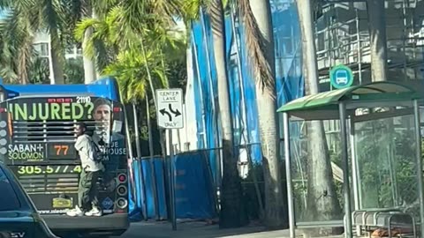 Guy Rides On Back Of Miami Dade Bus