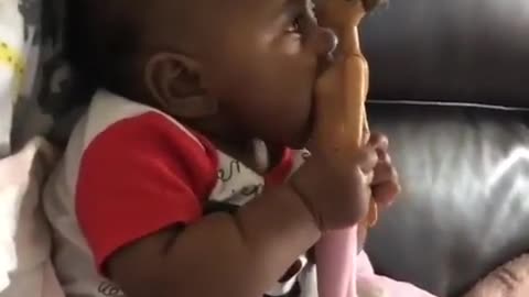 A baby having foreplay with a toy