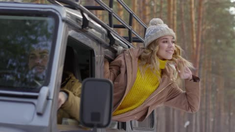 A Woman Leaning Out From A Vehicle Window Enjoying The Surroundings And Fresh Air