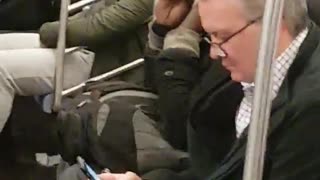 Guy uses scissors to trim beard on subway