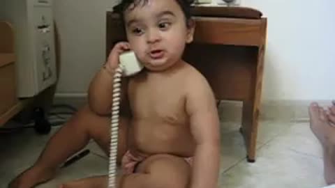 Cute baby has intense phone conversation