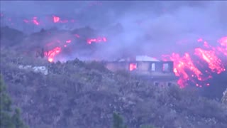 Buildings burn as La Palma volcano eruption continues