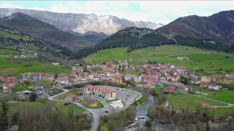 flying towards a village at picos de europa in spain