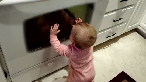 Baby tries to communicate with reflection