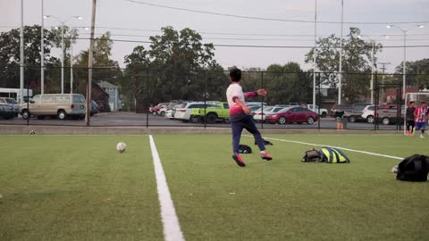 group of boys plays soccer in a soccer field