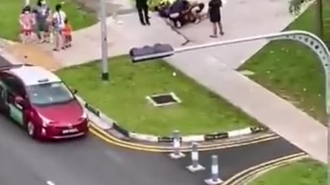 Crazy man attacking vehicle's middle of the road - finally someone stopped him- its crazy