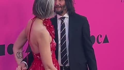 Keanu Reeves and girlfriend Alexandra Grant share a sweet moment on the carpet at the