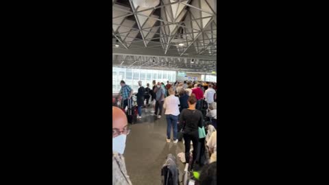 Passengers Wait in Long Queues in Frankfurt Airport