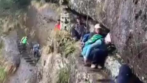 China man falls off of a cliff!